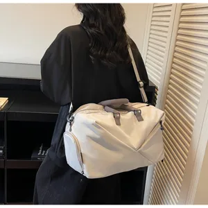 Large capacity travel duffel bag for gym and sports with cross-body strap and dry wet pocket.