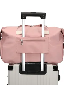 Large capacity travel duffel bag for women, waterproof gym bag with trolley sleeve pink.