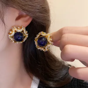 Vintage palace style rhinestone dark blue beaded clip-on earrings detailed close-up shot.