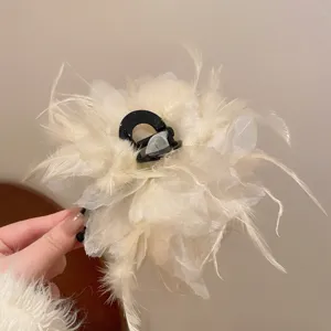 Detail view of the elegant beige feather mesh hair claw clip, showcasing delicate texture.