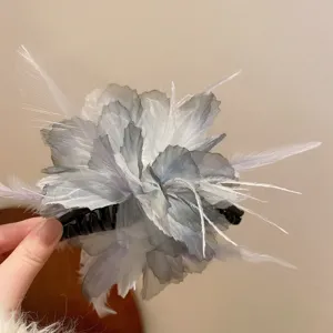 Exquisite grey feather hair claw clip detail, fluffy mesh flower design for elegant hairstyles.