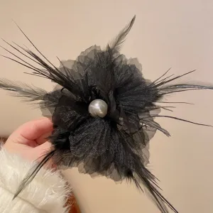 Exquisite black feather mesh hair claw clip with faux pearl detail, elegant detail shot.