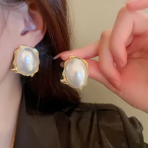 Retro baroque style pearl stud earrings featuring an irregular gold frame for elegant daily wear.