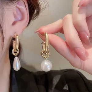 Vintage asymmetric pearl drop earrings for women, elegant French style gold metal studs.