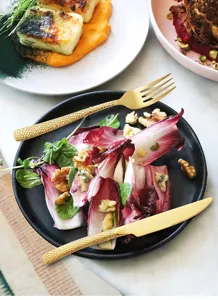 Gold hammered stainless steel knife and fork set, elegant cutlery detail for dining.