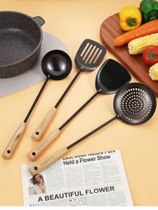 Black cast iron kitchen utensil set with wooden handles, durable cooking tools for home cooking.