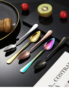 Detailed close-up of stainless steel serrated fruit spoons in multiple colors on dark scene.