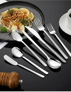 Stainless steel western tableware set including knives, forks, and spoons for home kitchen.