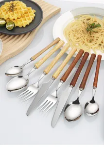 Stainless steel and wood handle cutlery detail showing fine craftsmanship and natural wood texture.