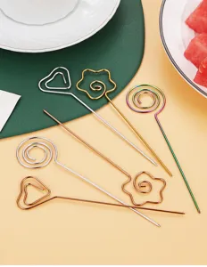 Detailed view of creative stainless steel fruit forks and colorful cocktail decorative picks.
