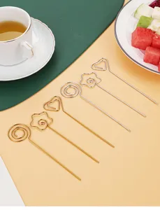 Stainless steel fruit picks cocktail forks decorative set closeup detail display.