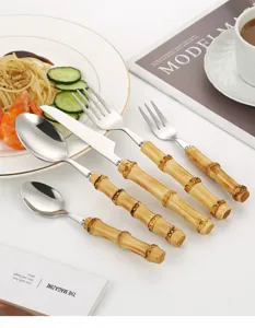 Stainless steel cutlery set with bamboo handles, vintage tableware for dining and steak.