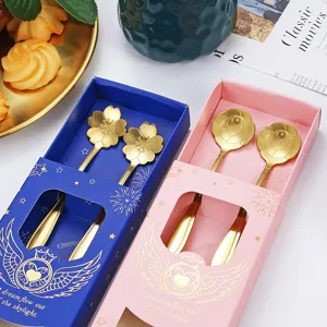Stainless steel spoon gift set with cherry blossom and rose designs in blue and pink boxes.