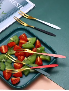 Detailed view of stainless steel fruit forks with colorful handles for daily desserts and salads.