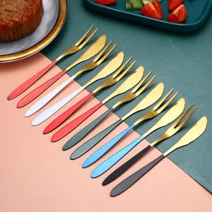Stainless steel fruit forks and cake knives set with colorful handles for kitchen and dessert.