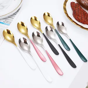 Stainless steel spoons set with colorful handles, elegant tableware for home kitchen and dining.