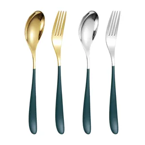 Stainless steel flatware set with gold and silver spoons and forks for home kitchen dining table.