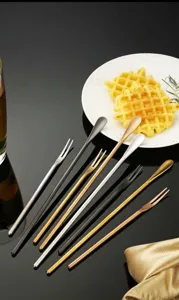 Detailed shot of stainless steel long handle mixing spoons and cocktail stirrers.