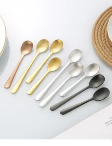 Close-up detail of assorted colored stainless steel small spoons for coffee and seasoning.