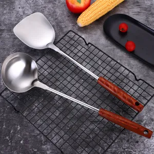 Stainless steel kitchen spatula and ladle set with wooden handle for cooking and frying.