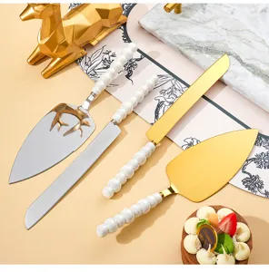 Detail view of stainless steel cake knife and spatula set with elegant pearl ceramic handles.