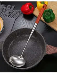 Stainless steel soup ladle detail showing long wooden handle and durable spoon bowl.