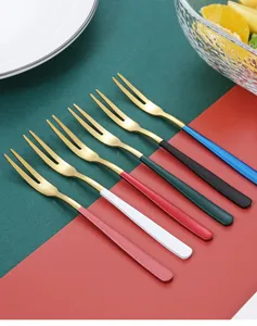 Stainless steel fruit fork detail showcasing gold tines and colorful handles for desserts and cakes.