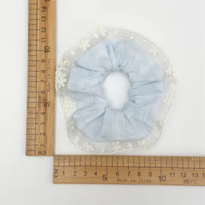 Sweet blue plaid hair scrunchie with white lace ruffle edge detail measurement view.