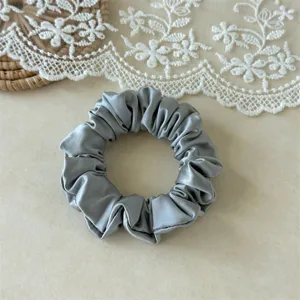 Satin scrunchie hair tie solid color soft elegant ponytail holder accessory detail view
