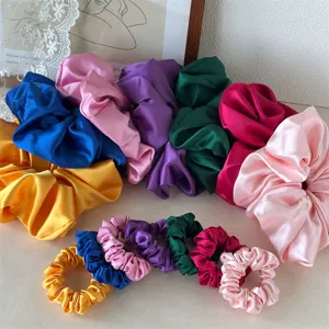Set of satin hair scrunchies in various vibrant colors, elegant large and small hair ties.