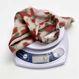 Floral chiffon triangle hair scarf detail showing lightweight 9.2g design and elastic band.