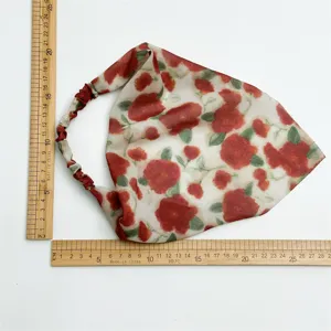 Chiffon floral triangle headscarf with elastic band, elegant women hair accessory detail.