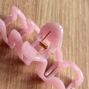 Pink wave hair claw clip for women, trendy aesthetic hair accessories for daily thick hair styling.