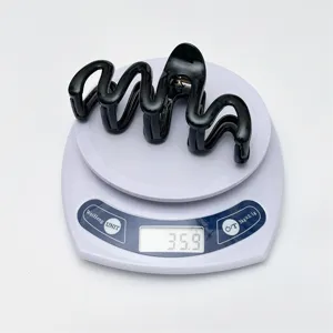 Black wavy hair claw clip for women, strong hold shark clip, lightweight daily hair accessory.