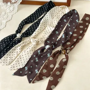 Close-up details of Korean style retro narrow silk scarves featuring pearl slider beads and chic prints.