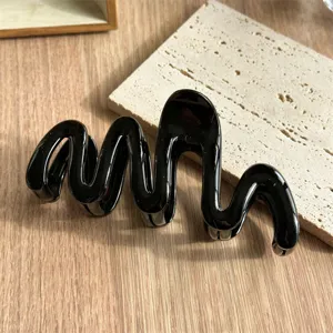 Black wavy hair claw clip for women, stylish minimalist hair accessory for daily elegant updos.