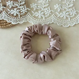 Satin hair scrunchie close-up detail, smooth ice silk texture for elegant daily ponytails.