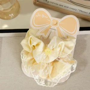 Sweet yellow plaid hair scrunchie with delicate lace trim and cute flower button detail.