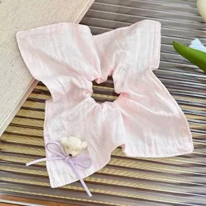 Detailed shot of sweet pink hair scrunchie with cute bear and bow, perfect for daily styling.