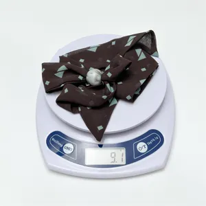 Vintage geometric print chiffon scarf necklace with marble bead pendant, elegant detail view.