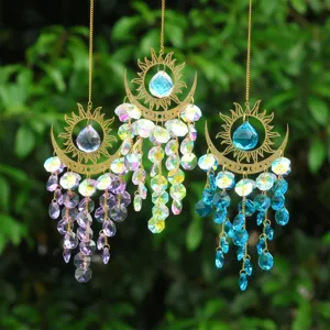 Crystal suncatcher detail hanging outdoors, colorful light reflections on natural leaves.