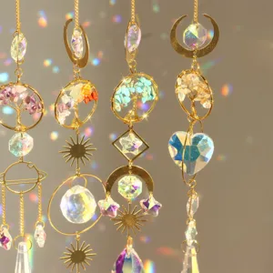 Detail view of golden tree of life crystal suncatchers with natural stones and hanging prisms.