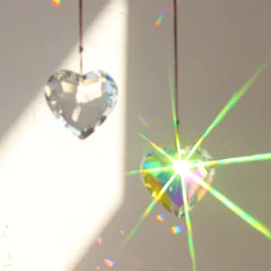 Crystal heart prism suncatcher detail hanging decor for window lighting and rainbow effects.
