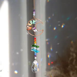 Crystal suncatcher detail shot, handmade tree of life moon design with colorful beads.