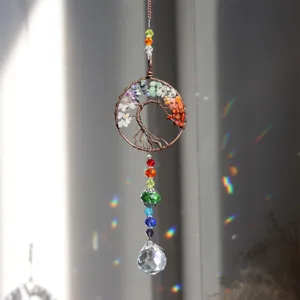 Exquisite crystal suncatcher with tree of life design, sparkling faceted pendant for home decor.