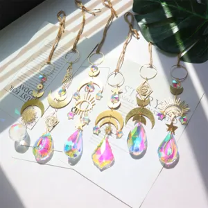 Crystal suncatcher detail showing hanging prism pendants with moon star and eye metal motifs.