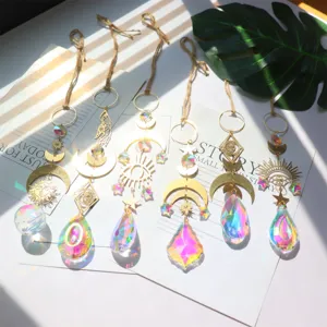 Detailed view of bohemian crystal suncatchers hanging prism pendants with sun moon and evil eye.
