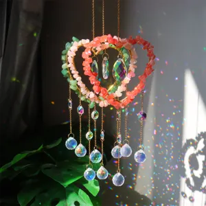 Close-up of handmade crystal suncatcher with natural gemstone chips and rainbow refractions.