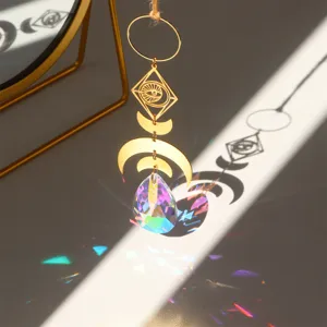 Detail view of crystal suncatcher window hanging prism with moon and evil eye design for decor.