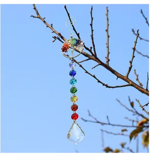 Crystal suncatcher detail shot showing the colorful tree of life pendant hanging outdoors.